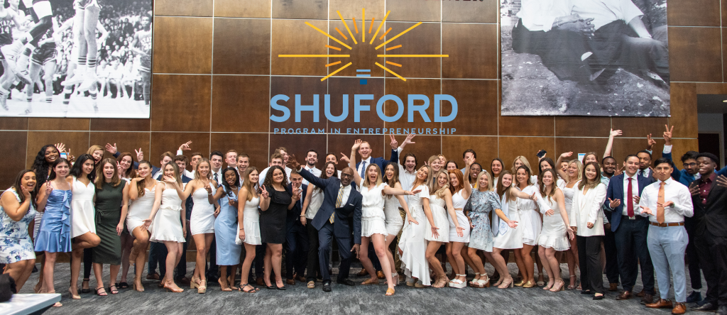 Students and Bernard Bell ’82 (MBA ’91), executive director of the Shuford Program in Entrepreneurship, at the program's graduation ceremony in spring 2022.