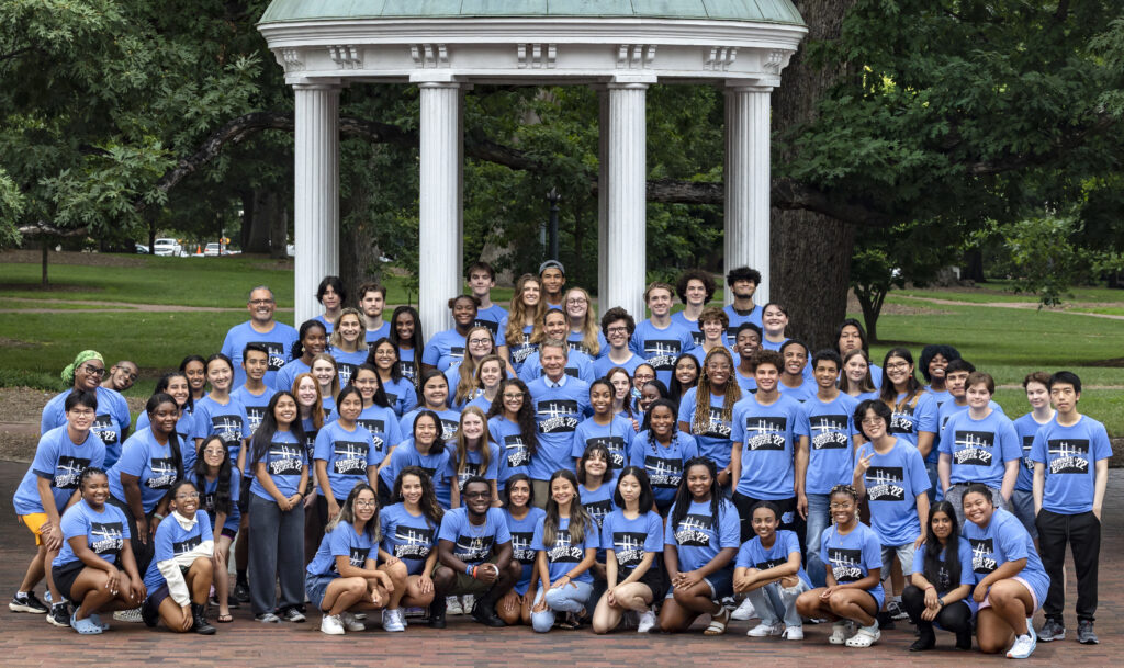 Students in the Summer Bridge program pose for a portrait with Chancellor Kevin M. Guskiewicz on July 25, 2022, at the Old Well on the campus of the University of North Carolina at Chapel Hill.