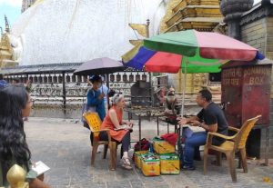 Lauren Leve interviews Prabin Buddhacharya, a hereditary Buddhist priest from a family that claims descent from the first priest to conduct worship at Swayambhu. When not performing rituals, he sells butter lamps that visitors light as offerings. (photo by Alok Tamrakar)